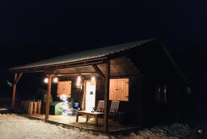 a small cabin with a table and chairs in the dark at Nexus B2 in Făgeţel