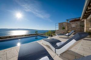 a villa with a swimming pool with a view of the ocean at Villa Belle Murvica An Exquisite 3 Bedroom Villa Overlooking the Adriatic Sea in Murvica