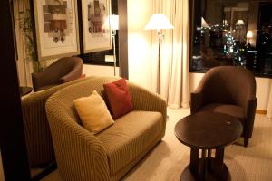 a living room with a couch and two chairs and a table at ANA Crowne Plaza Toyama, an IHG Hotel in Toyama