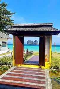 a small building with a door leading to the beach at Thanya Beach Resort - SHA Plus in Ko Ngai