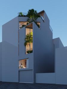 a building with a tree in the window at CRIN.HOUSE Homestay in Hanoi