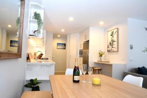 a kitchen and dining room with a table with wine glasses at Steamboat Unit 1 in Thredbo