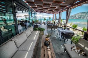 a restaurant with a couch and tables and the ocean at En Vie Beach Boutique Hotel - Adults Only in Alanya