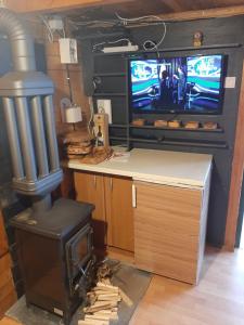 a living room with a stove and a tv at Livari Viewpoint in Livari
