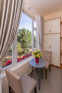 a living room with a table and a large window at Thang Lap Hotel in Da Lat