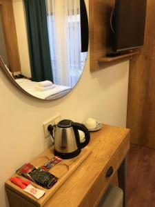 a tea kettle on a counter with a mirror at Pege Hotel in Istanbul
