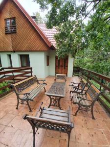 a group of benches sitting on a patio at Zelený dom in Modra