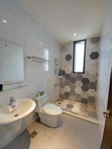 a bathroom with a toilet and a sink and a shower at 愛分享民宿 Love & Share House in Hualien City