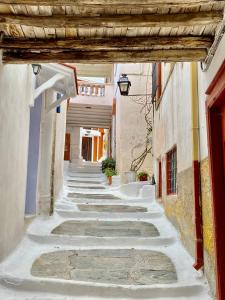 an alley in an old town with a building at Lion House II in Ioulis