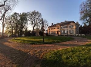 una casa grande con una carretera delante de ella en La Maison Verneuil, en Paray-le-Monial