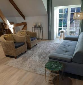 a living room with two couches and a rug at Hotel B - Boskapelhoeve in Buggenhout