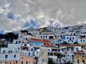 a group of white houses on a hill at Lion House II in Ioulis