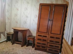 a room with a wooden floor and a wooden cabinet at Guesthouse Pushkina in Khuzhir
