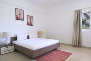 En eller flere senge i et værelse på Le Sifah - Golf Lake Apartments