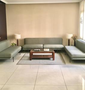 a living room with two couches and a coffee table at Hotel Crunia I A Coruña in A Coruña