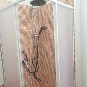 a shower with a shower head in a bathroom at Suite La Rosa Dei Venti in Catanzaro