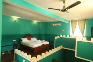 sypialnia z łóżkiem w pokoju z zielonymi ścianami w obiekcie Hillfort Hotels & Resorts Yelagiri w mieście Yelagiri