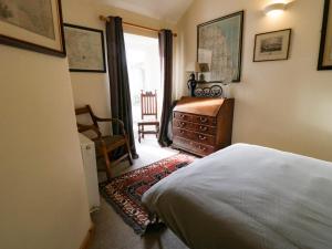 a bedroom with a bed and a dresser and a chair at 11 Main Street in Scarborough