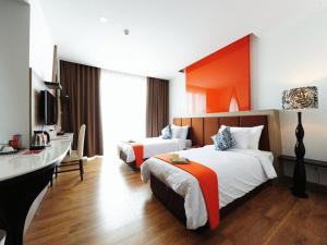 Ένα ή περισσότερα κρεβάτια σε δωμάτιο στο Prajaktra Design Hotel