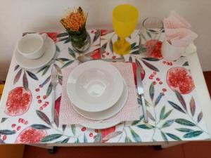 a white table topped with plates of food at Lighthouse Farm Backpackers Lodge in Cape Town