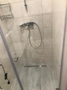 a shower with a glass door in a bathroom at Arcadia sky in Odesa +55 photos