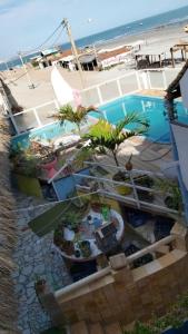 an overhead view of a pool with palm trees and a beach at Beiral Pousada E Restaurante in Ponta do Mel +17 photos