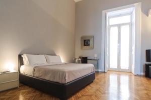 A bed or beds in a room at Spaccanapoli Comfort Suites