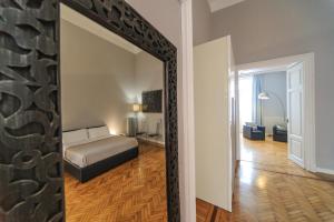 A bed or beds in a room at Spaccanapoli Comfort Suites