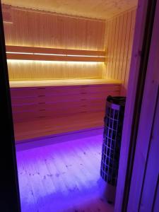 a room with a sauna with a purple light at Rezerwat Wielin in Wielin