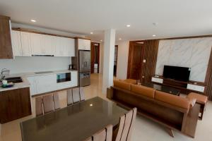 een keuken en een woonkamer met een bank en een tafel bij Korea Hotel Bac Giang in Làng Thành