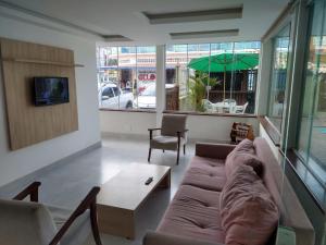 a living room with a couch and a coffee table at Pousada Espirito do Mar in Cabo Frio