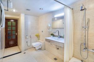 a bathroom with a toilet and a sink and a shower at Octave Jamayca Hotel in Bengaluru +27 photos