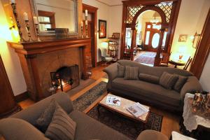 a living room with two couches and a fireplace at The Blenman Inn in Tucson