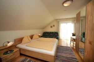a small bedroom with a bed and a couch at Sonnhof in Villach