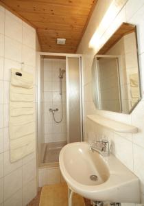 a white bathroom with a sink and a shower at Sonnhof in Villach