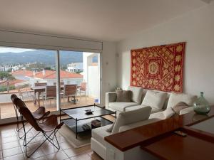 a living room with a couch and a table at Beachfront Duplex with Terrace and Sea Views - in Cadaqués