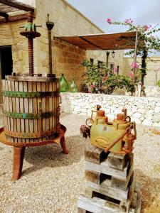 a wooden barrel and a machine on a pile of wood at Masseria Cataldo in Corigliano dʼOtranto