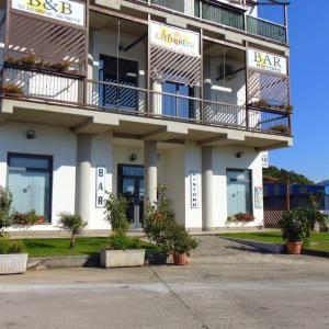 a large white building with a bar sign on it at B&B Le Ginestre in Colleferro