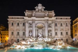a large building with a fountain in front of it at Palace fontana di trevi home in Rome
