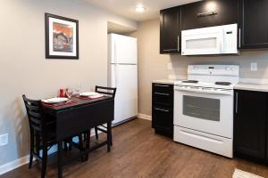 a kitchen with a table and a white stove top oven at The Lewis House in Laramie