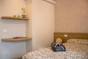a bedroom with two beds and a teddy bear sitting on the bed at Salgari Uno in Marina di Ragusa