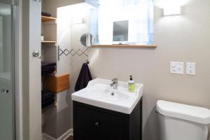 a bathroom with a sink and a toilet and a mirror at The Lewis House in Laramie