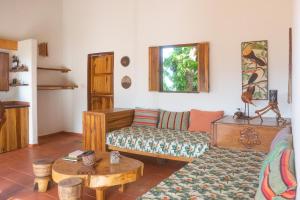 
a living room filled with furniture and a painting at Mundo Nuevo Eco Lodge in Minca

