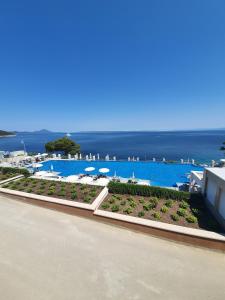 a view of a pool with the ocean in the background at Apartmaji Punta in Veli Lošinj