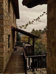 a wooden deck with benches on a building at Helydorea zen BED& BREAKFAST in Synikia Mesi Trikalon