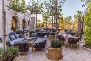 a patio with couches and tables and chairs at Suter Palace Heritage Boutique Hotel in Bucharest