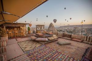 a room with pillows and hot air balloons in the sky at Divan Cave House in Goreme