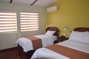 Tempat tidur dalam kamar di Hotel Cayapas Esmeraldas