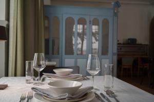 a table with plates and wine glasses on it at Hotel Erica in Langenbruck