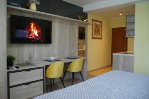 a room with a kitchen with a fire on the wall at Apartmány Kvetná in Rajecké Teplice